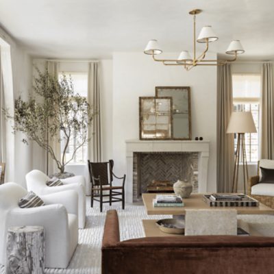 Neutral living room with windows, chairs, decor.